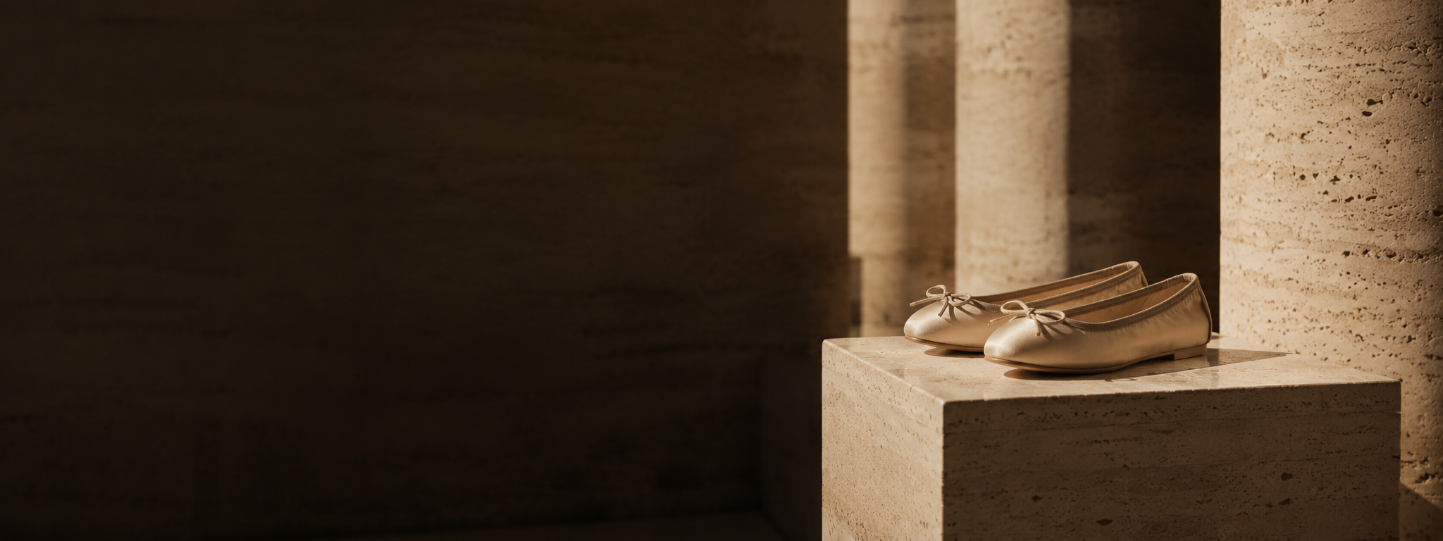 Pair of tan flats on a plinth
